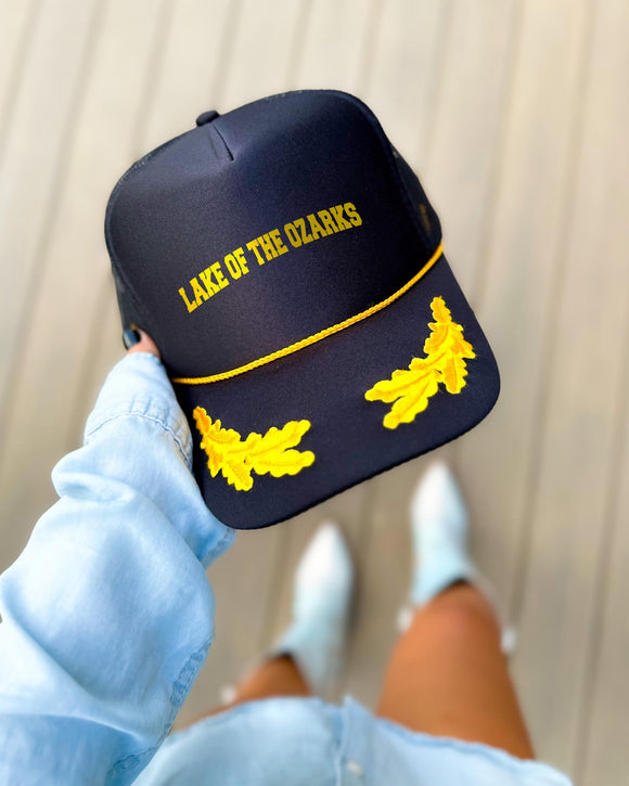 Lake of the Ozarks Missouri black trucker hat with gold varsity lettering, gold rope and gold oak leaves on the visor
