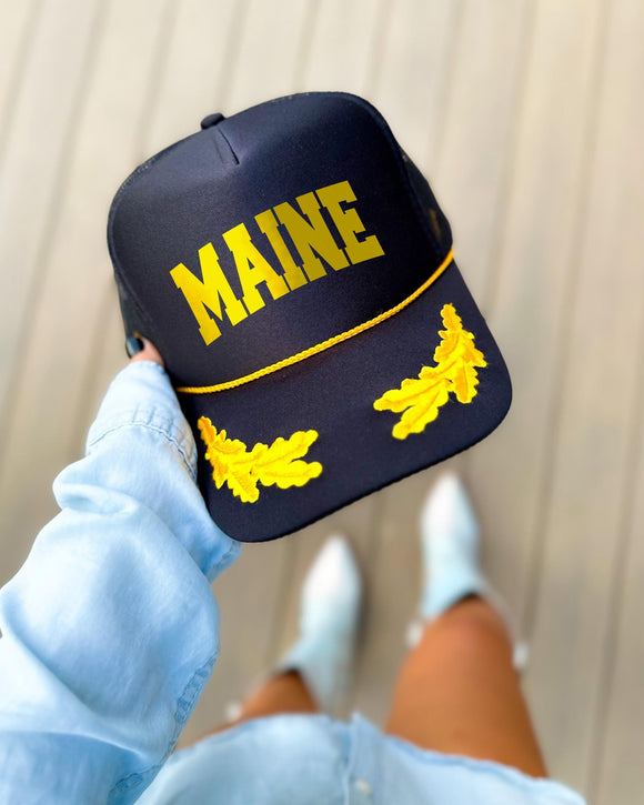 Maine black trucker hat with gold varsity lettering, gold rope and gold oak leaves on the visor