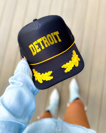 Detroit Michigan black trucker hat with gold varsity lettering, gold rope and gold oak leaves on the visor