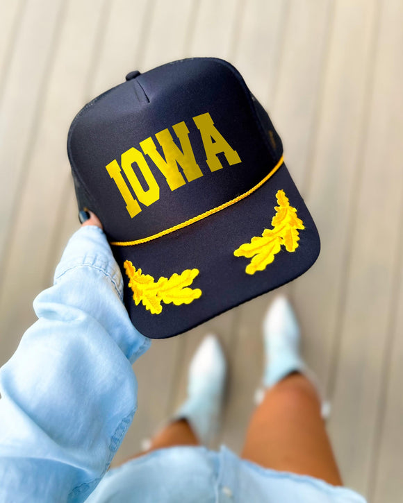 Iowa black trucker hat with gold varsity lettering, gold rope and gold oak leaves on the visor