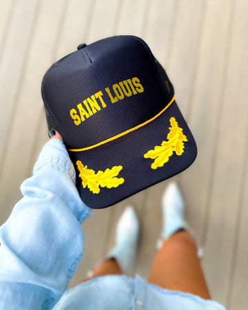 St. Louis Missouri black trucker hat with gold varsity lettering, gold rope and gold oak leaves on the visor
