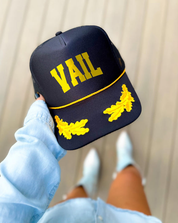 Vail Colorado black trucker hat with gold varsity lettering, gold rope and gold oak leaves on the visor